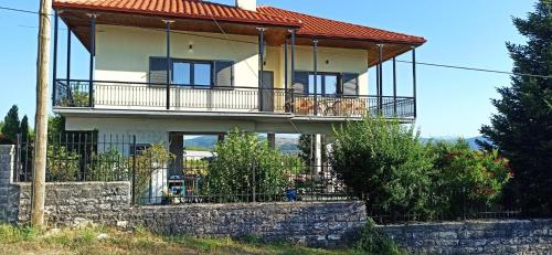 a large house with a balcony on a hill at Pavlos House in Asfáka