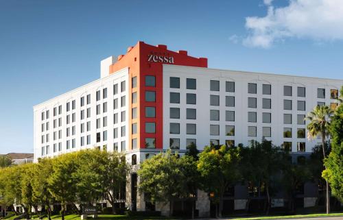 a white building with a krispy kreme sign on it at Hotel Zessa Santa Ana, a DoubleTree by Hilton in Santa Ana