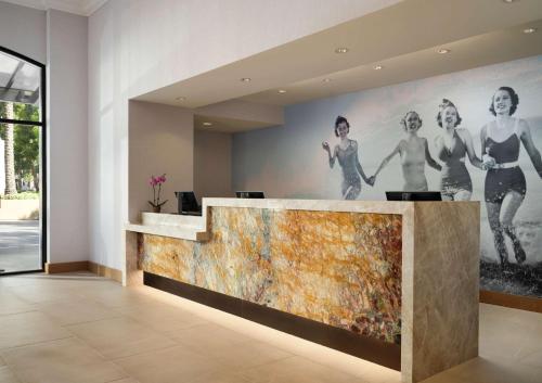 a lobby with a large painting on the wall at Hotel Zessa Santa Ana, a DoubleTree by Hilton in Santa Ana