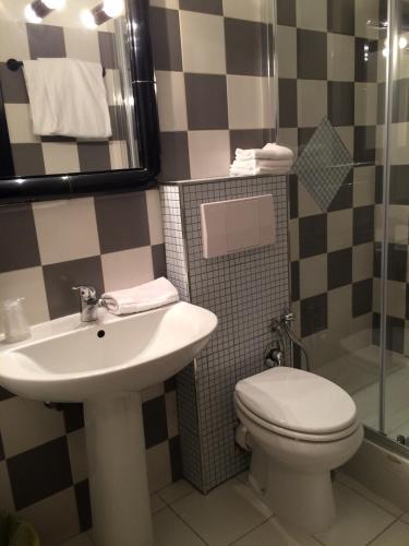 a bathroom with a toilet and a sink at Hotel Letizia in Orte