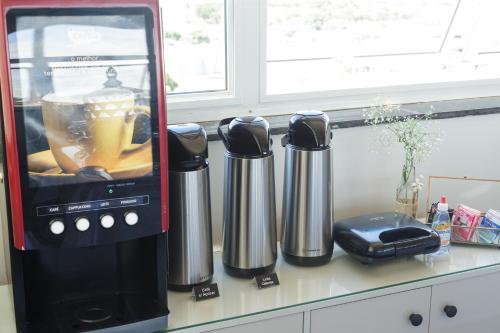 a coffee maker sitting on a counter next to at VILLAGE GOLDEN HOTEL in Jales