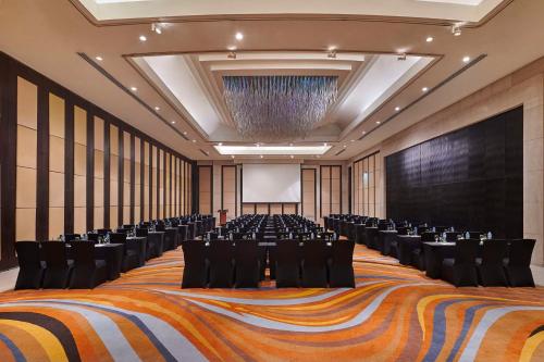 a large room with chairs and a projection screen at Waldorf Astoria Cairo Heliopolis in Cairo