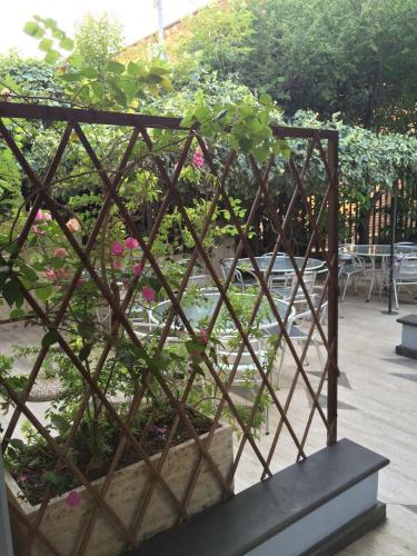 a metal trellis with plants in a garden at Hotel Letizia in Orte