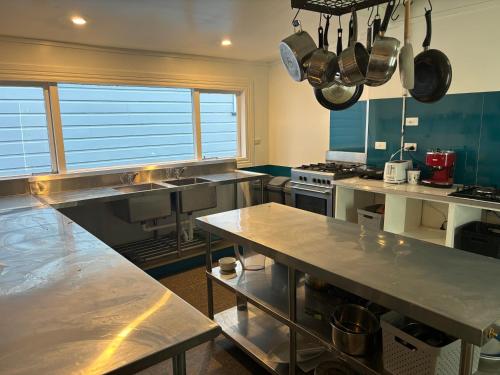 a large kitchen with stainless steel counter tops and appliances at Worldwide Backpackers in Wellington