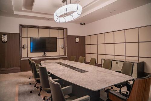 a conference room with a large table and chairs at Waldorf Astoria Doha West Bay in Doha