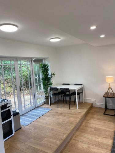 a living room with a dining room table and a table at Rose lodge in Dublin