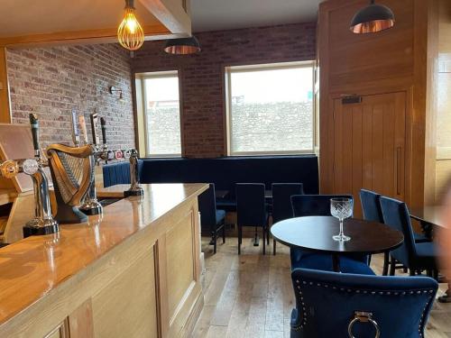 a bar with chairs and a table in a restaurant at The Royal Crest in Liverpool