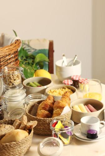 a table topped with baskets of bread and other food at Entre Ruas Apartments in Coimbra