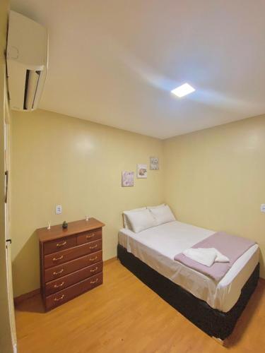 a small bedroom with a bed and a dresser at Princesa Hostel in Belém