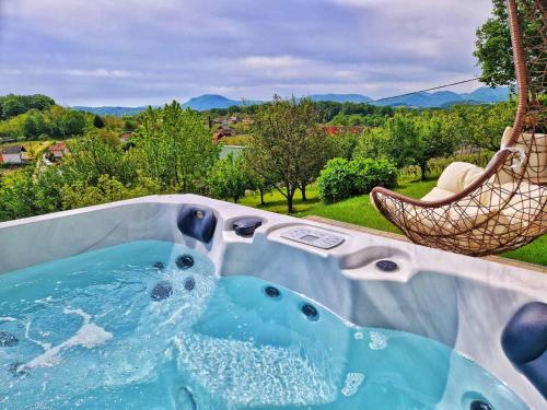 a jacuzzi tub with a view of a yard at LA MIA STORIA in Beretinec