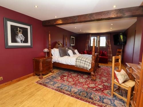 a bedroom with a bed and a red wall at Farm View Hall in Harrogate