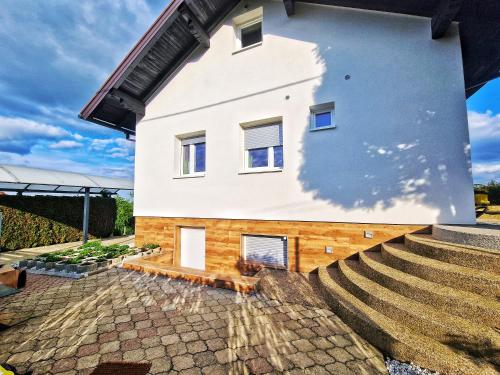 a house with stairs on the side of it at LA MIA STORIA in Beretinec