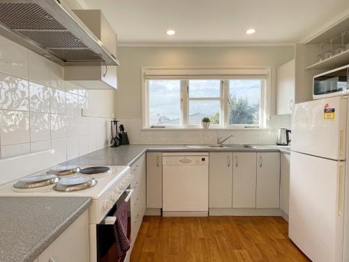 a kitchen with white appliances and a white refrigerator at Home in central Auckland in Auckland