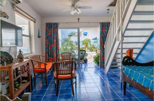 a living room with a staircase and a table and chairs at Marazul D1 in Westpunt