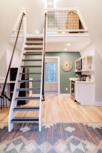 a white staircase in a room with a kitchen at Unique a frame cabin located near Old Rag Mountain in Etlan