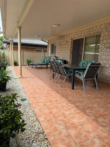 a patio with a table and chairs on it at Anchor Iluka in Iluka