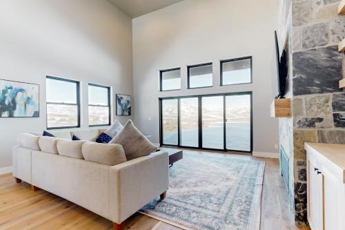 a living room with a couch and a stone fireplace at Sparkling Waters in Heber City