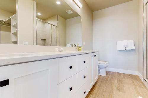 a white bathroom with a sink and a toilet at Sparkling Waters in Heber City