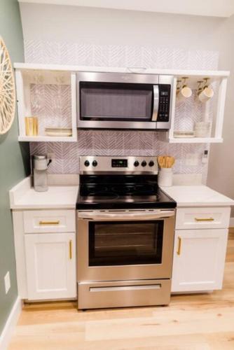 a kitchen with a stove and a microwave at Unique a frame cabin located near Old Rag Mountain in Etlan