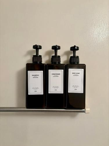 three bottles of soap sitting on a shelf at Koiwa Detached house 小岩駅にある戸建のおうち in Tokyo