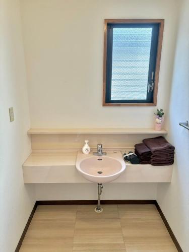 a bathroom with a sink and a window at Koiwa Detached house 小岩駅にある戸建のおうち in Tokyo