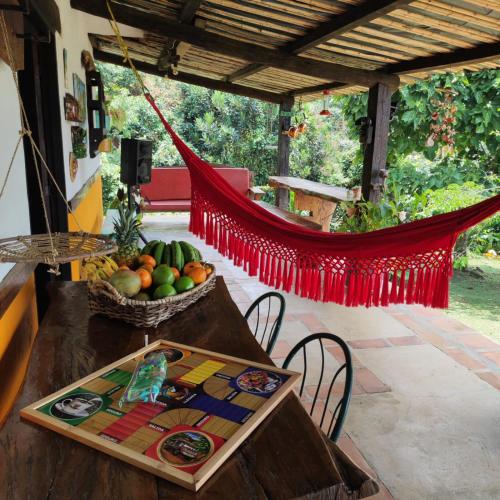 a table with a bowl of fruit and a hammock at La Villa The View in Pance