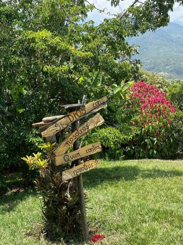 a directional sign in the middle of a field at La Villa The View in Pance