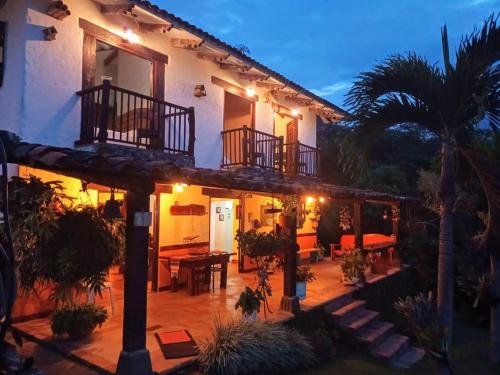 a house with a patio and a palm tree at La Villa The View in Pance