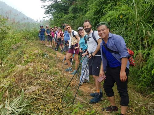 a group of people walking down a trail at Bình Bản Liền Homestay - Vang A Binh in Bắc Hà