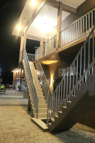 a staircase leading up to a building at night at U APPARTMENTS in Paramaribo