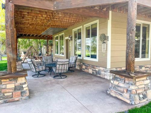 a porch of a house with chairs and a table at Bear Lake Cabin with Lake Views in Fish Haven