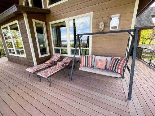 a porch with two benches on a house at Bear Lake Cabin with Lake Views in Fish Haven