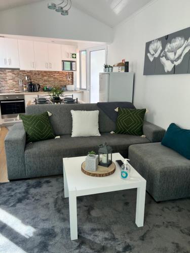 a living room with a couch and a table at Casa da Cascata do Segredo in Vila Franca do Campo