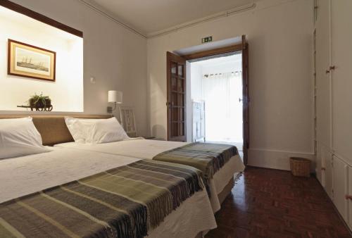 A bed or beds in a room at Quinta da Vargem