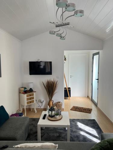 a living room with a couch and a table at Casa da Cascata do Segredo in Vila Franca do Campo
