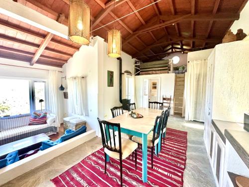 a dining room with a table and chairs at Olive Mill Cottage in Skopelos Town