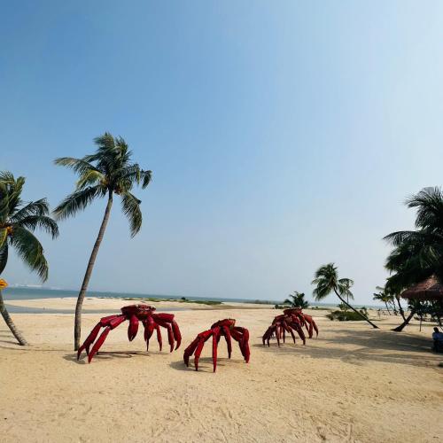 a group of crabs on a beach with palm trees at Seaview 2B1R 6pax Condo Forest City 2E-2117 in Gelang Patah