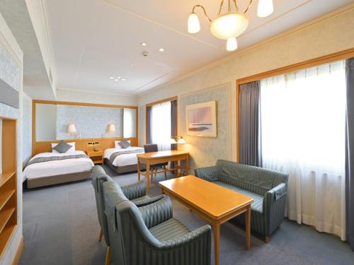 a hotel room with a bed and a bedroom at Takamatsu Kokusai Hotel in Takamatsu