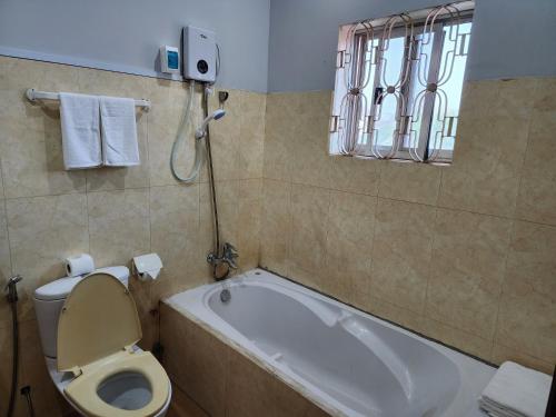 a bathroom with a tub and a toilet and a sink at Youth's Dream Fulfillment Association in Siem Reap