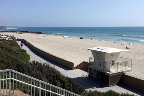 a beach with a retaining wall and the ocean at Golf - Beach - Legoland - Shopping - Dining in Carlsbad