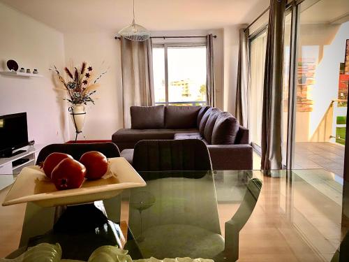 a living room with a couch and a table with apples on it at Green&Blue in Ribeira Grande