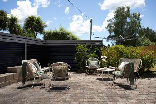 a group of chairs and tables on a brick patio at Legana Lodge - A home away from home - Catering for up to 12 guests in Legana