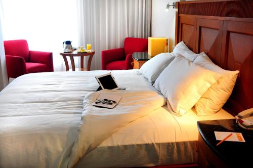 a hotel room with a bed with a laptop on it at Ambiance Suites in Cancún