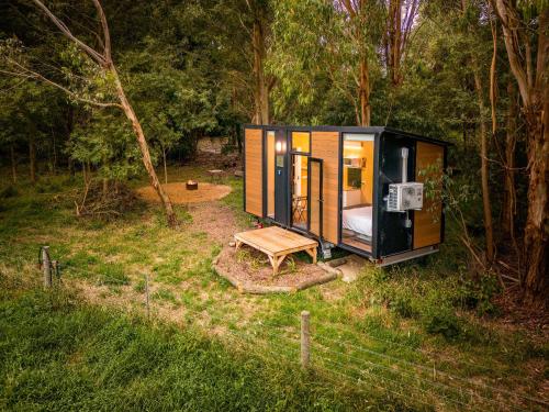 a tiny house in the middle of a forest at Buffalo Plains Tiny House by Tiny Away in Buffalo
