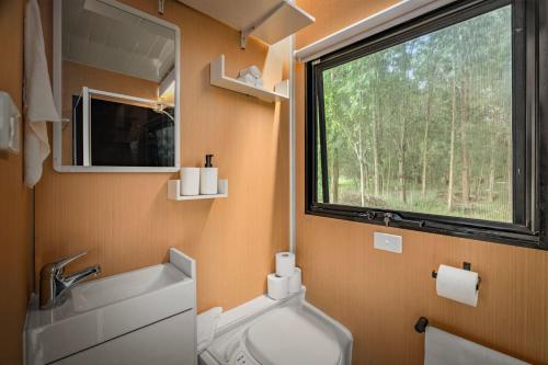 a bathroom with a sink and a large window at Buffalo Plains Tiny House by Tiny Away in Buffalo
