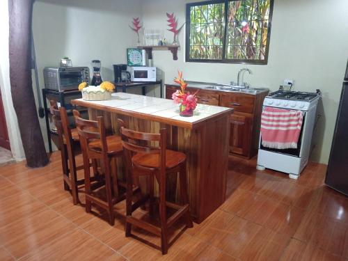 a kitchen with a island in the middle of a room at Finca La Paz in Puerto Viejo