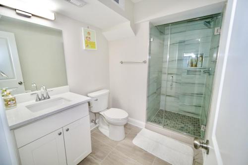 a bathroom with a shower and a toilet and a sink at The Lenny: Modern Boutique Loft in Washington