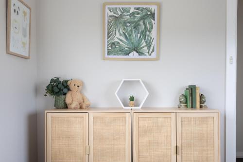 a teddy bear sitting on top of a wooden cabinet at Legana Lodge - A home away from home - Catering for up to 12 guests in Legana