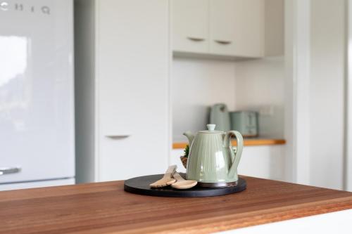 a tea kettle and pair of sandals on a counter at Legana Lodge - A home away from home - Catering for up to 12 guests in Legana