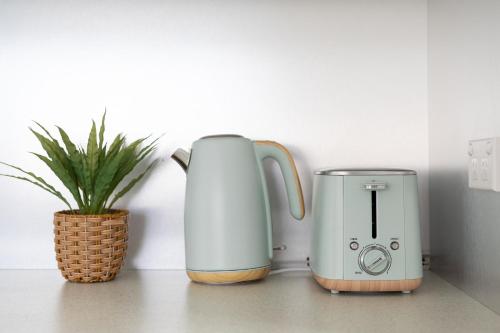 a toaster sitting on a counter next to a plant at Legana Lodge - A home away from home - Catering for up to 12 guests in Legana
